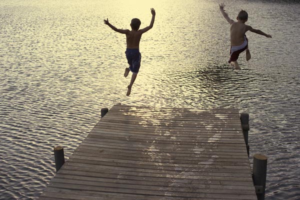 Two Boys Diving off Dock into Lake